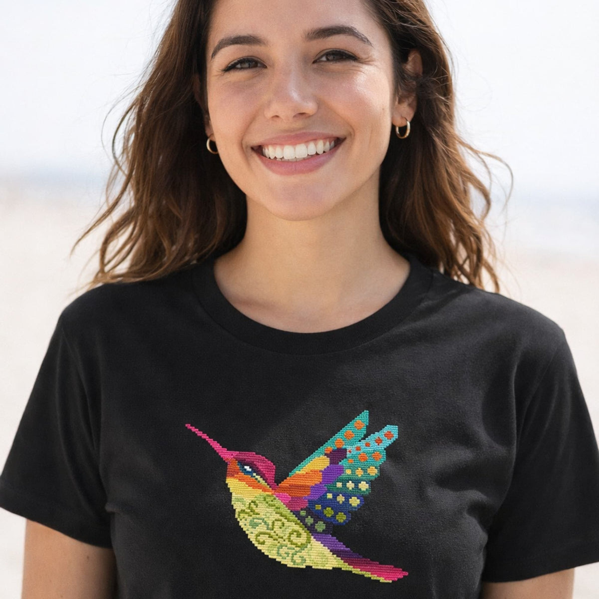 Hummingbird embroidery kit design shown on black t-shirt, counted cross stitch set including floss, fabric and printed pattern.