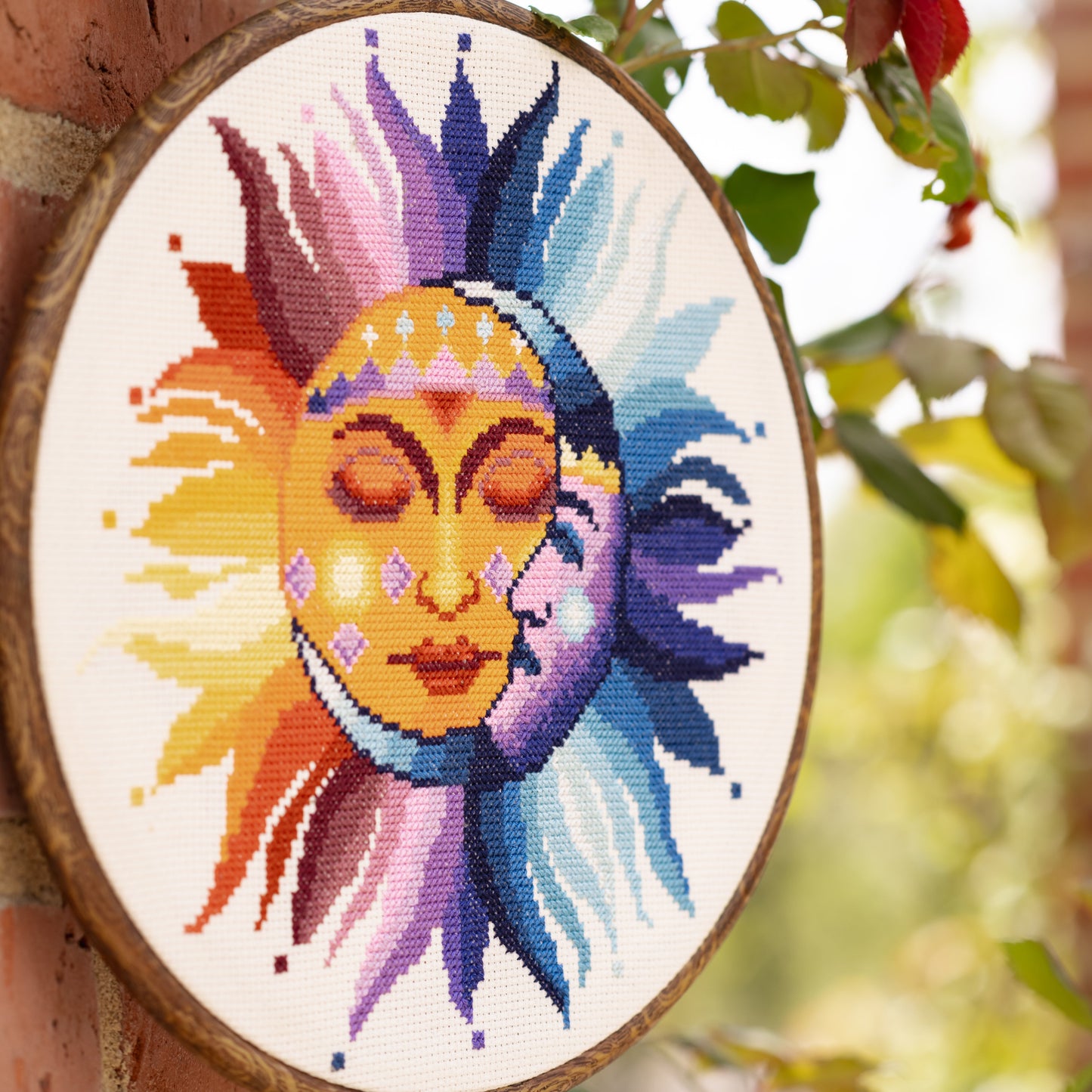 Unique celestial cross stitch design showing sun and moon together