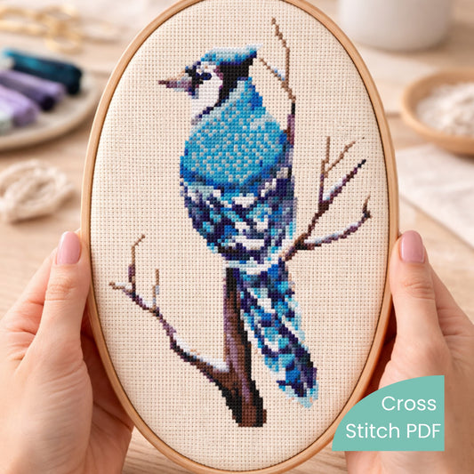 Blue Jay Cross Stitch Pattern PDF displayed in oval embroidery hoop, blue bird embroidery design, modern bird counted cross stitch pattern.