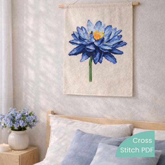 Blue Lotus Cross Stitch Pattern PDF digital download displayed as wall hanging textile art with blue lotus flower embroidery.