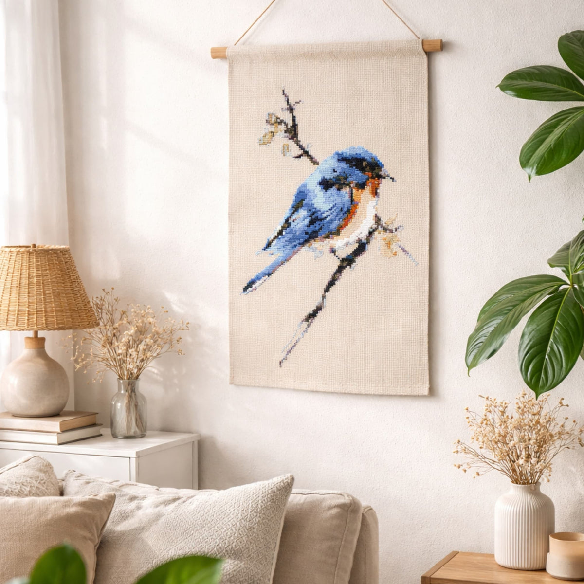 Blue bird cross stitch wall hanging displayed as a finished example. Design available as a complete cross stitch kit from Happy x Craft.
