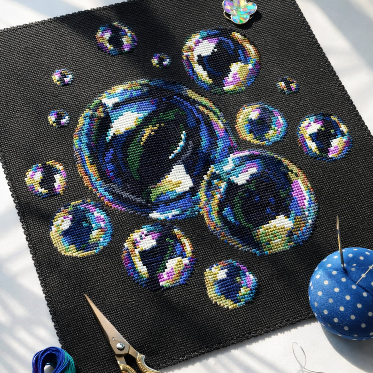 Close-up of soap bubbles cross stitch embroidery on black fabric, detailed colorful bubble design, modern cross stitch pattern PDF