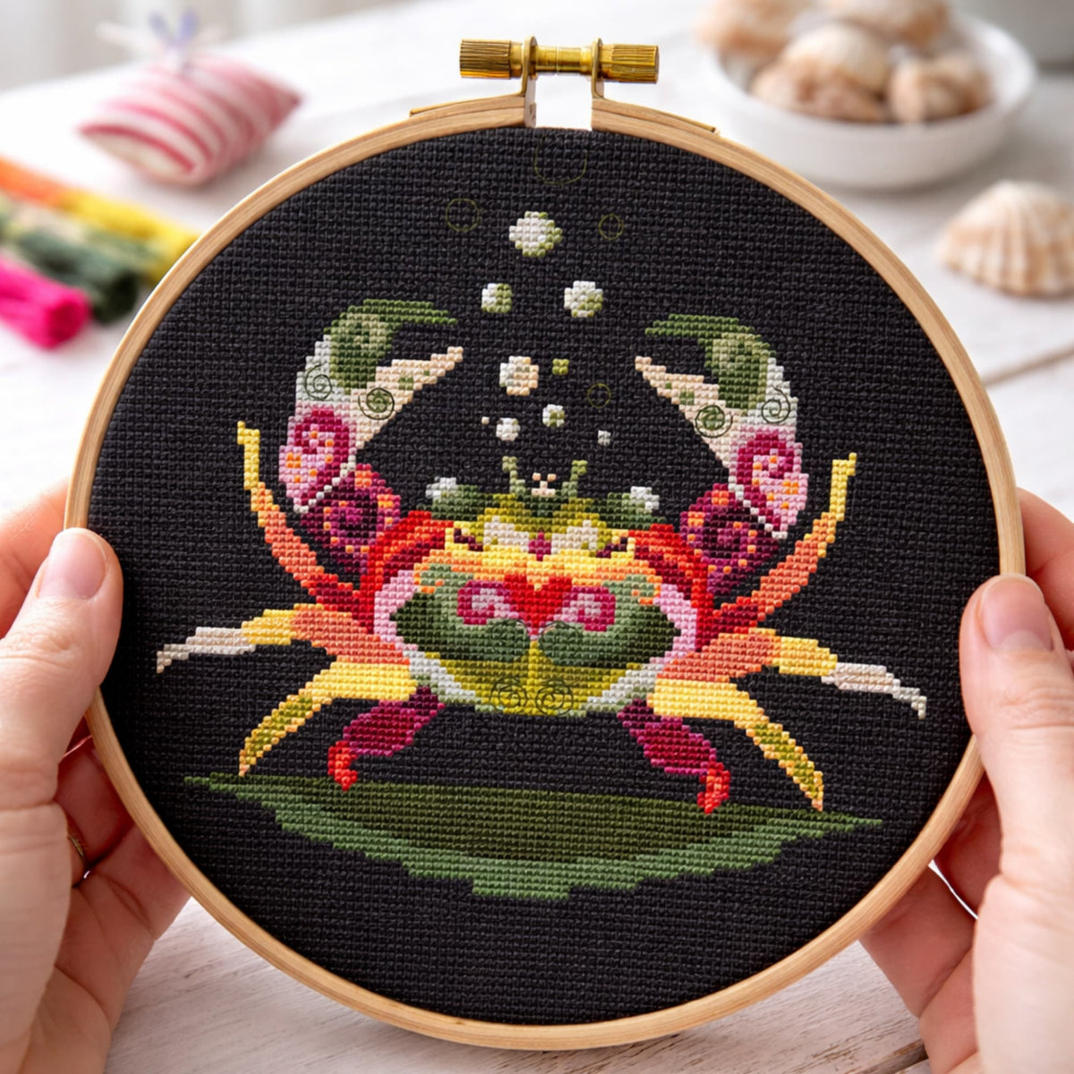 Colorful crab cross stitch kit displayed in embroidery hoop on black fabric, ocean crab DIY embroidery kit with modern folk style