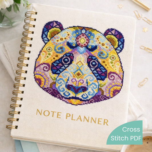 Colorful mandala panda cross stitch pattern stitched on fabric notebook cover, decorative animal embroidery, handmade journal design