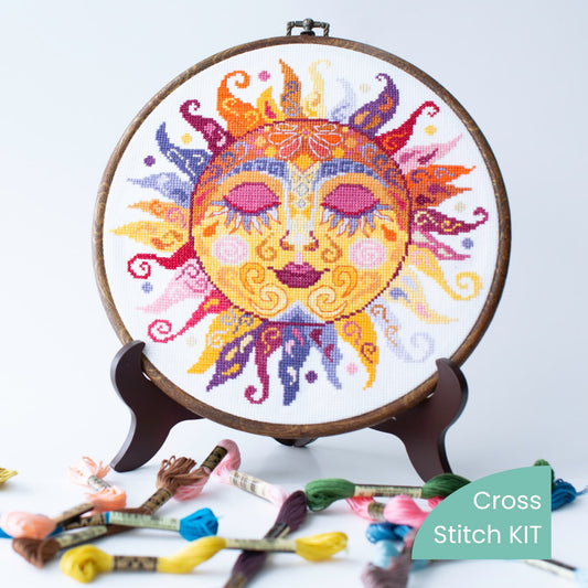 Colorful swirl sun counted cross stitch kit with embroidery hoop, threads and vibrant folk sun design ready for stitching.