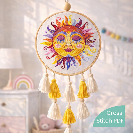 Colorful swirl sun cross stitch pattern displayed in embroidery hoop with tassels, handmade folk sun embroidery wall decoration, child room decor.