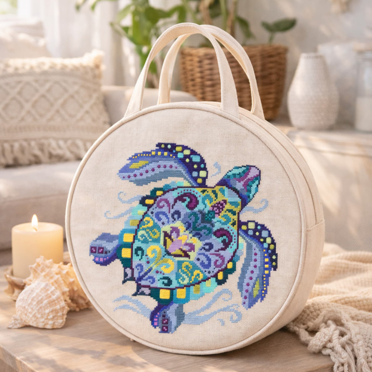Complete sea turtle cross stitch kit shown on round linen bag, ocean inspired embroidery set