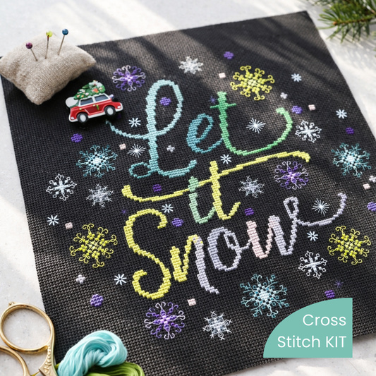 Counted Cross Stitch Kit Let It Snow – Winter Snowflake Cross Stitch Kit stitched on black Aida fabric with colorful threads