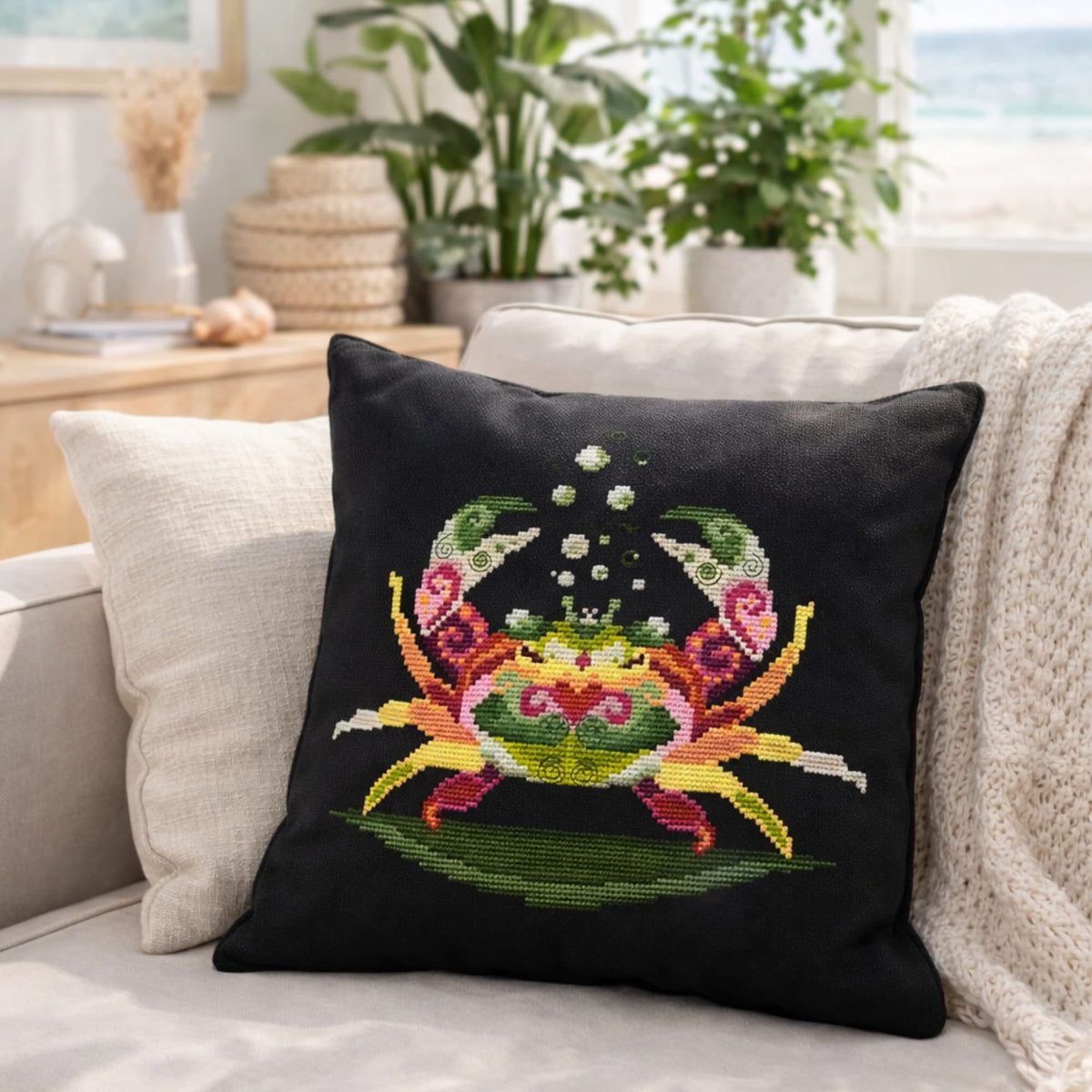 Crab cross stitch kit design displayed on decorative pillow, colorful ocean crab embroidery project for home decor