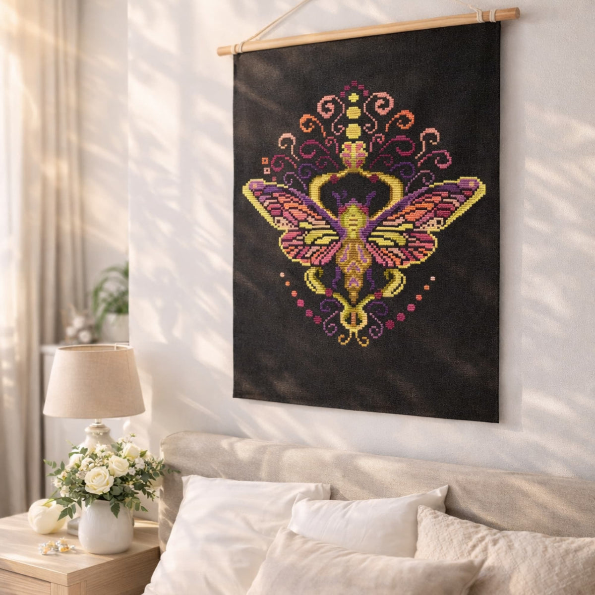 Cross Stitch Pattern Colorful Purple Moth PDF – Folk Ornament Moth Embroidery Design displayed as decorative wall hanging on black fabric