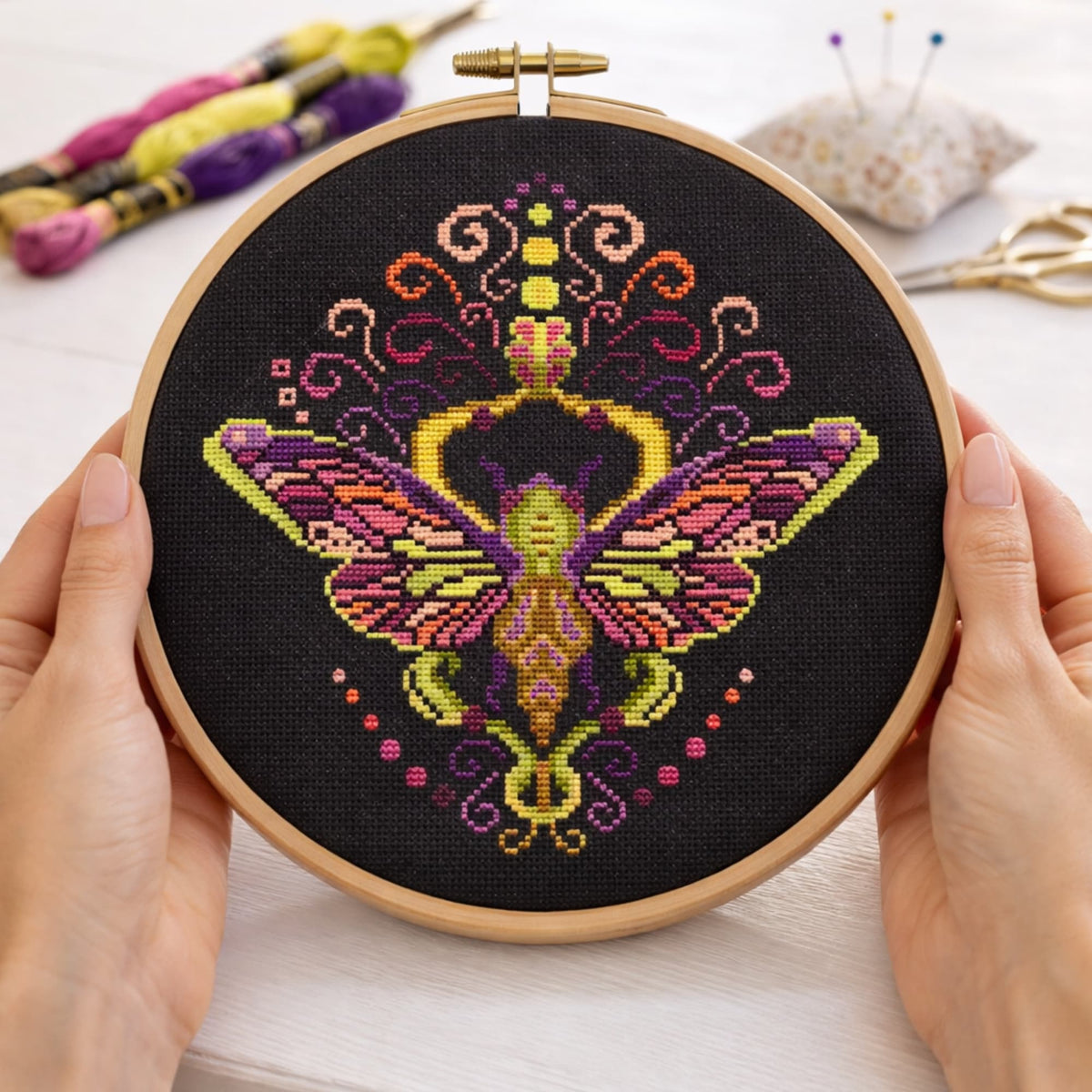 Cross Stitch Pattern Colorful Purple Moth PDF – Folk Ornament Moth Embroidery Design stitched in wooden embroidery hoop on black Aida