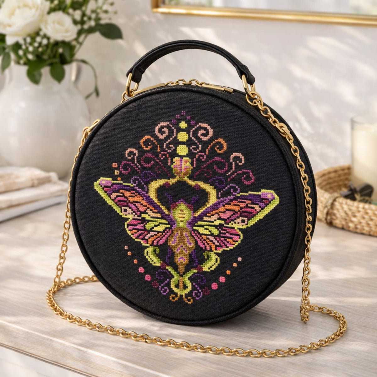 Cross Stitch Pattern Colorful Purple Moth PDF – Folk Ornament Moth Embroidery Design stitched on round black handbag