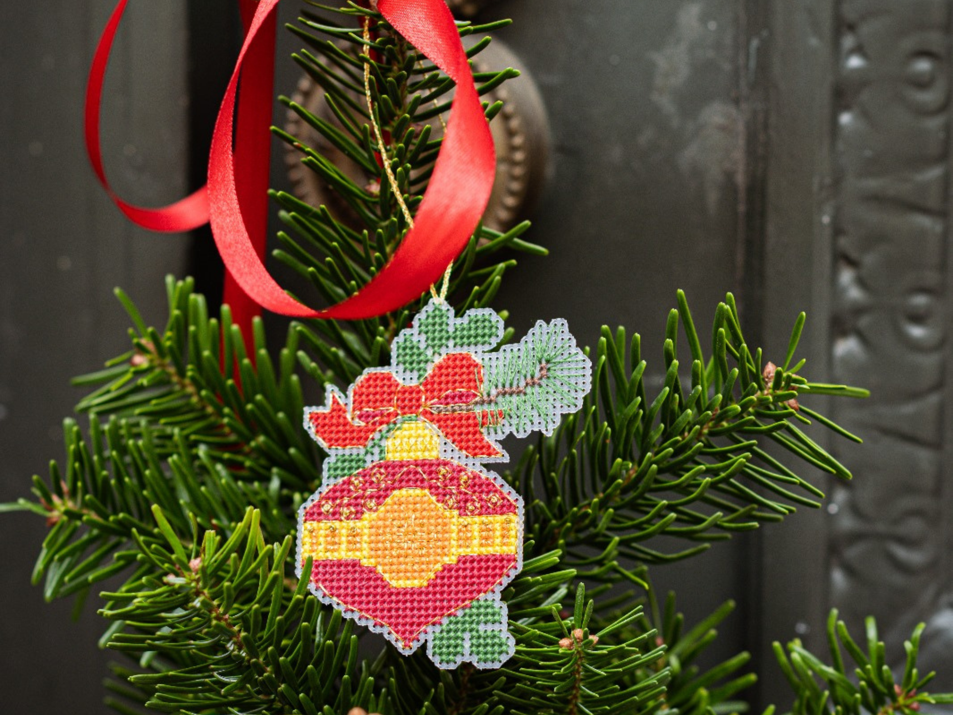 Cross stitched red ornamnet on plastic canvas