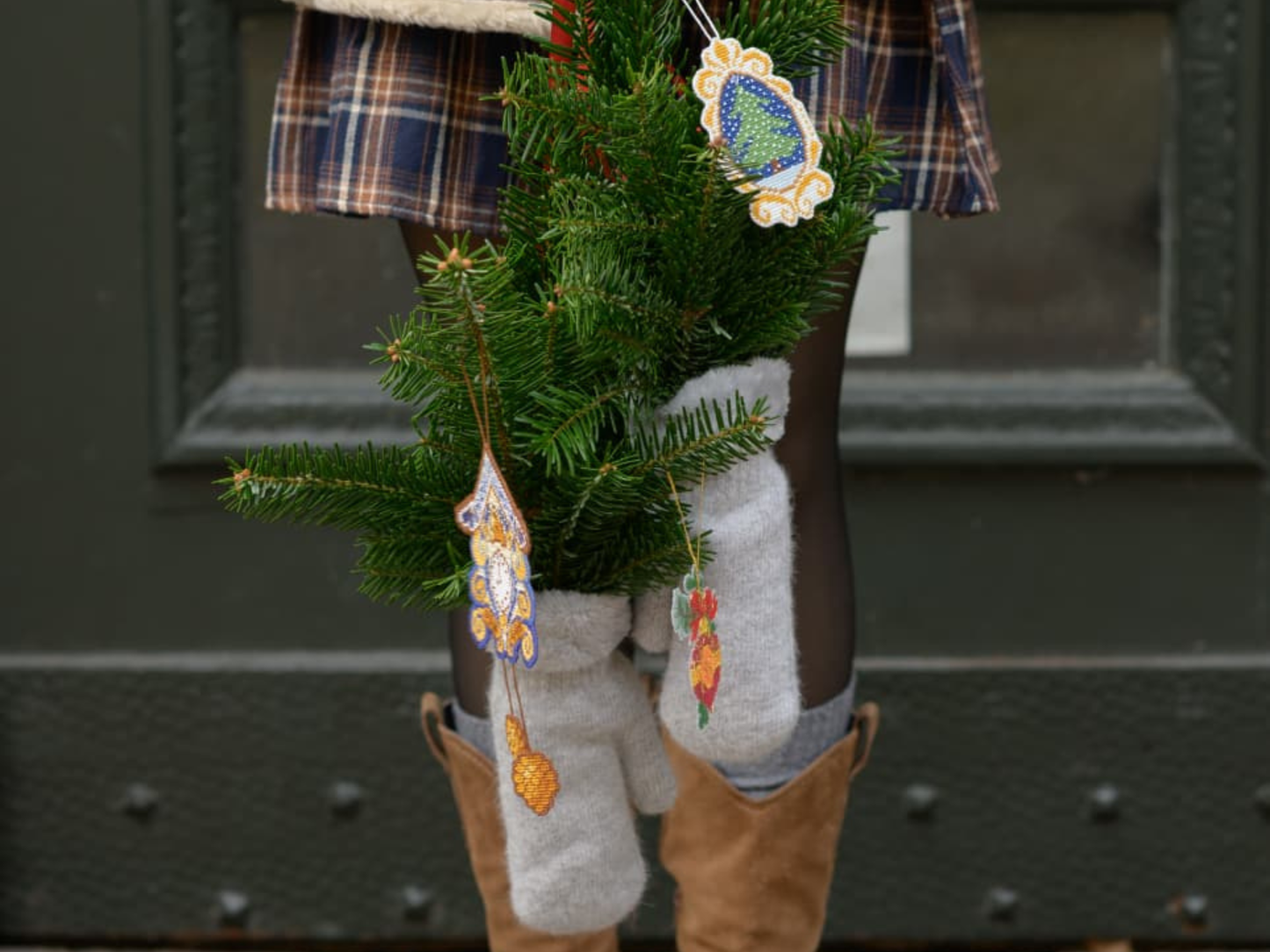 Christmas cross stitched ornaments on canvas hanged on Pine branches
