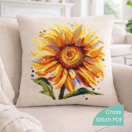 Decorative pillow with a colorful cross stitch sunflower design on a beige couch.