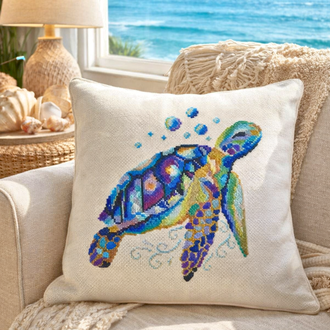 Decorative pillow with sea turtle cross stitch embroidery in coastal living room setting