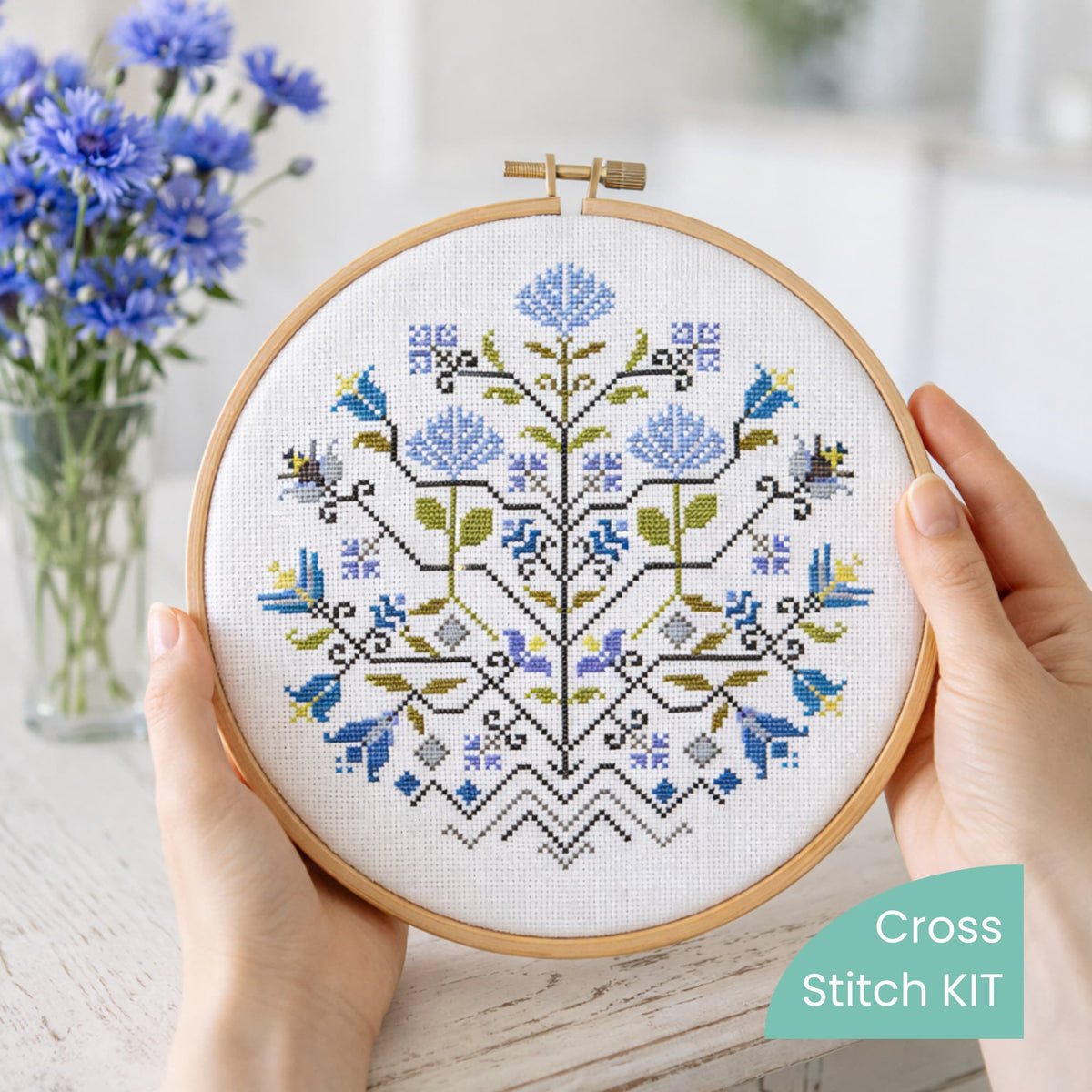 Finished embroidery hoop featuring Blue Flowers Sampler cross stitch design. Example of completed project stitched using the complete cross stitch kit. Traditional floral counted cross stitch artwork.