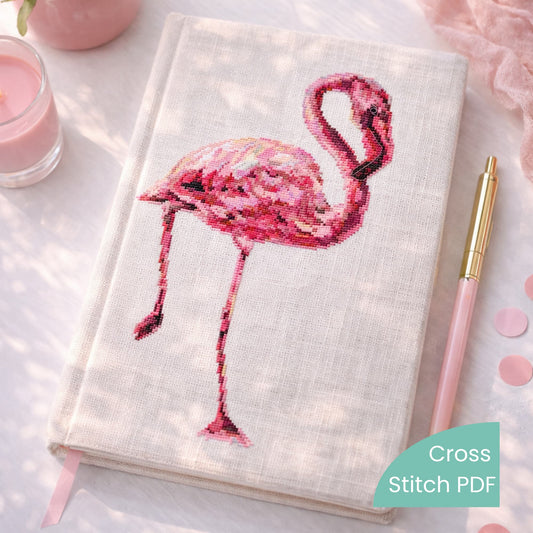 Flamingo Cross Stitch Pattern PDF displayed on embroidered notebook cover with pink flamingo design, modern bird counted cross stitch pattern.