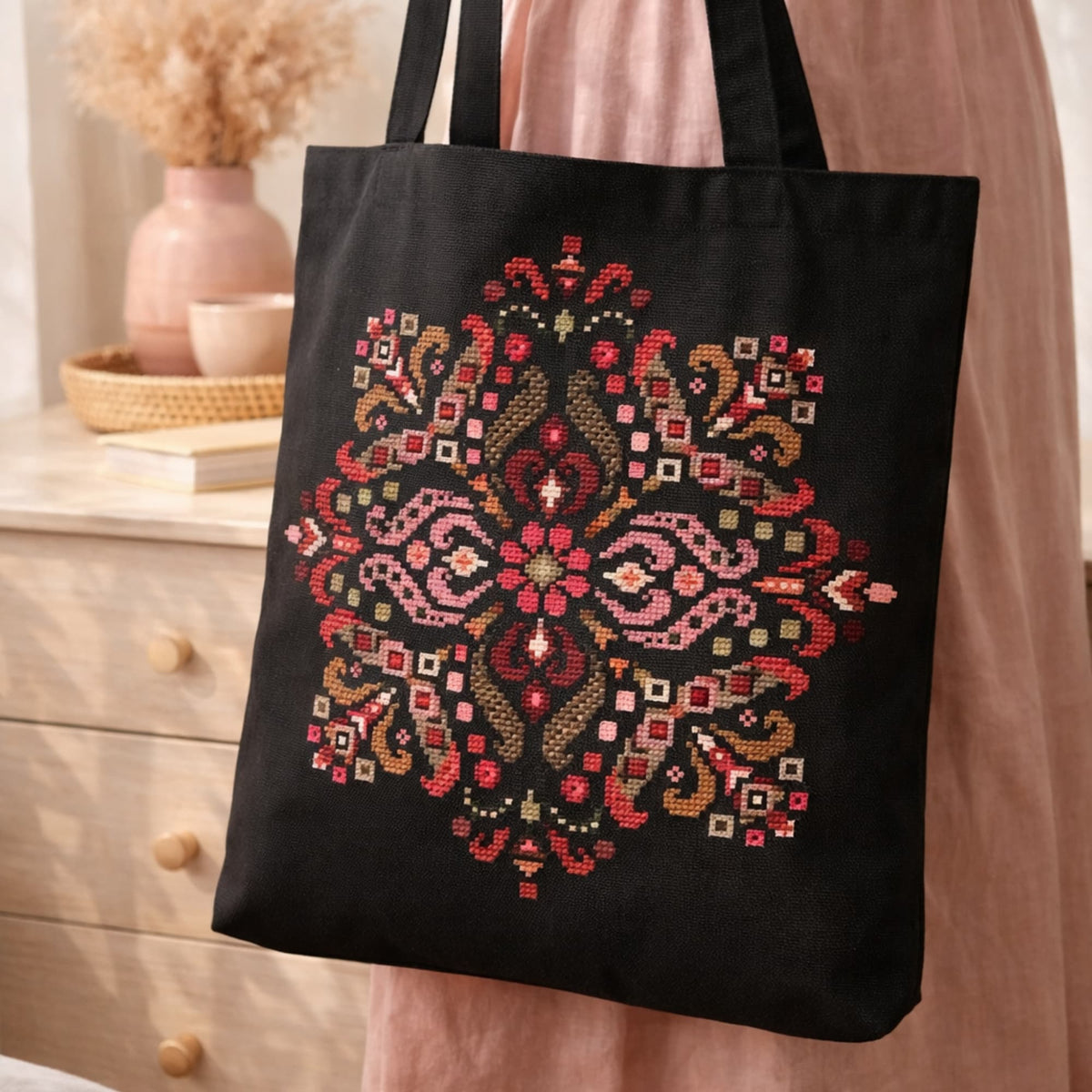 Folk mandala cross stitch kit displayed on black tote bag, traditional embroidery DIY kit with symmetrical folk ornament