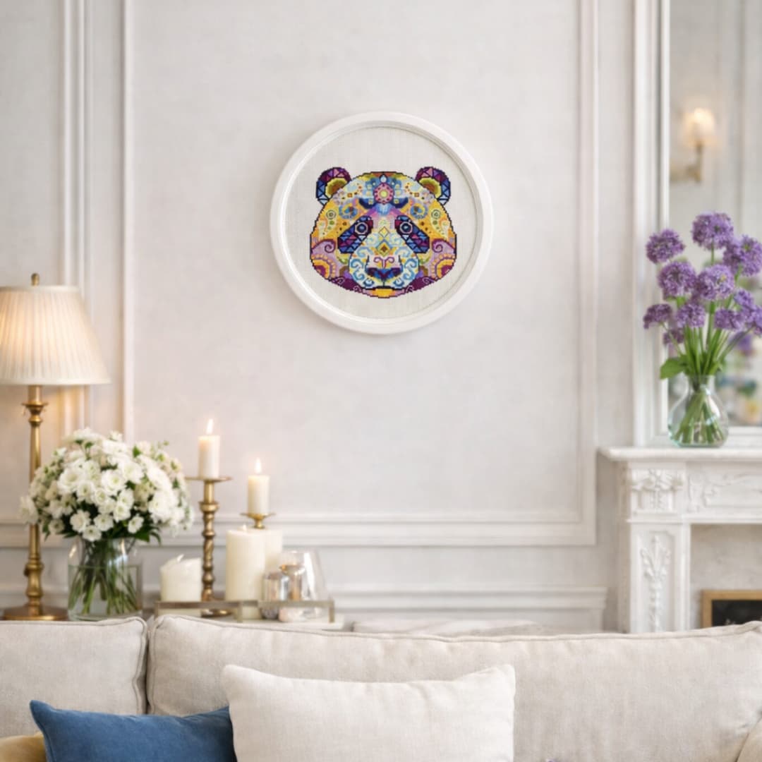 Folk modern panda counted cross stitch kit shown as framed wall art with colorful mandala panda embroidery decor.