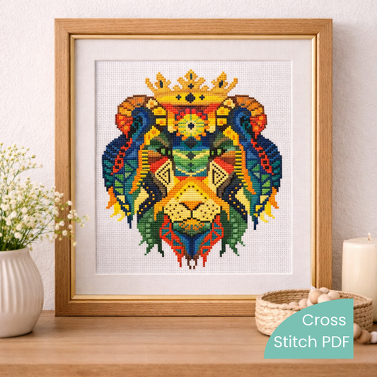 Framed crowned lion cross stitch embroidery artwork displayed on wooden shelf, colorful geometric lion needlework home decor.