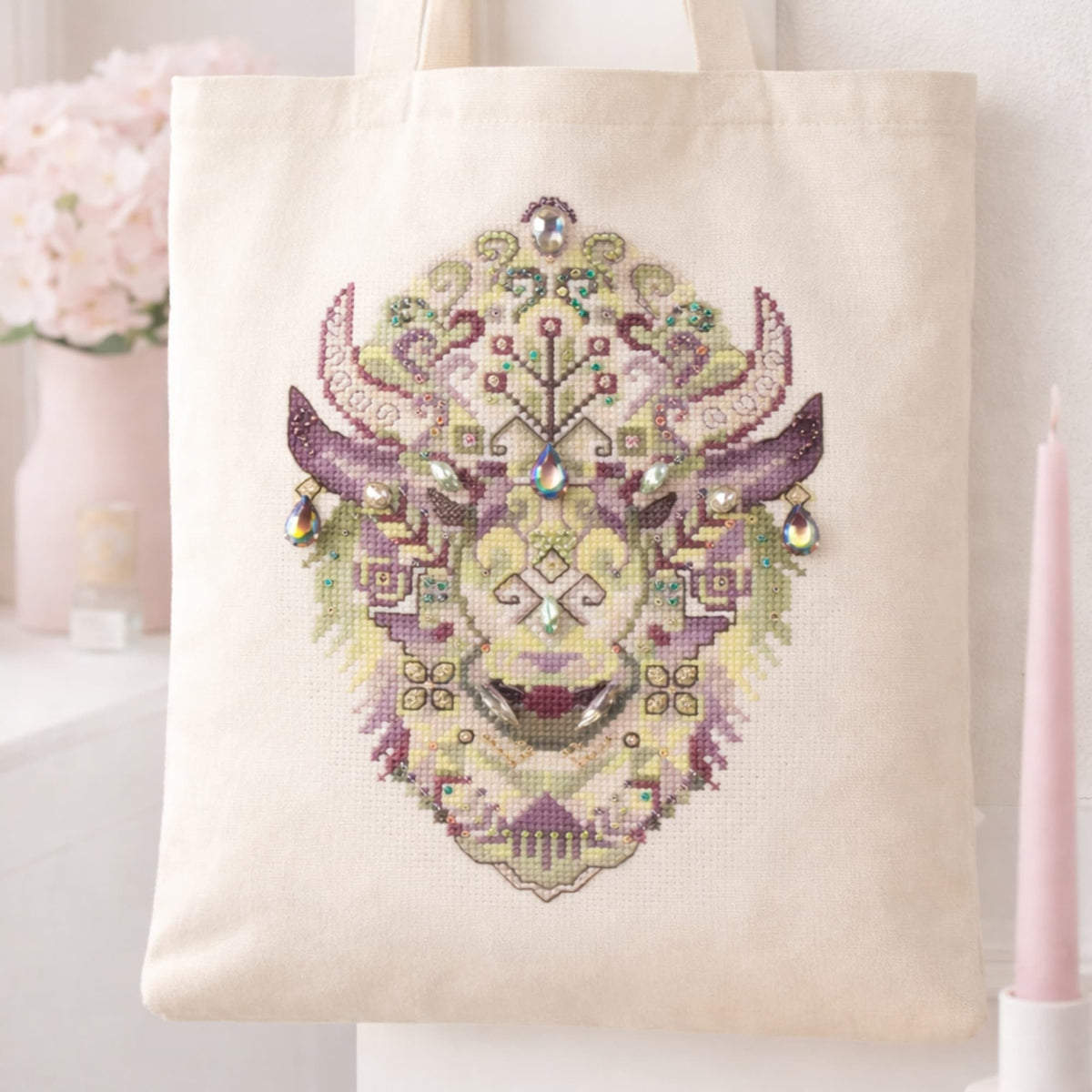 Geometric bison cross stitch pattern shown on tote bag mockup, modern tribal animal embroidery design, printable PDF pattern