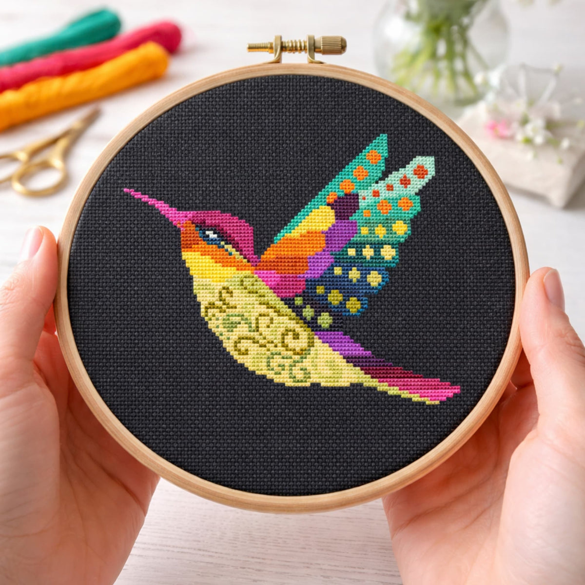 Hummingbird counted cross stitch kit stitched on black fabric in hoop, colorful modern bird embroidery set with threads, fabric and instructions included.