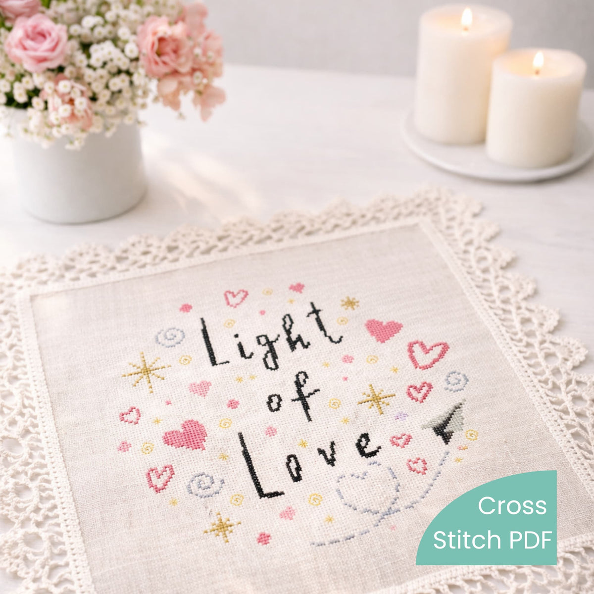 Light of Love cross stitch pattern PDF displayed as flat lay embroidery with pink hearts and gold stars