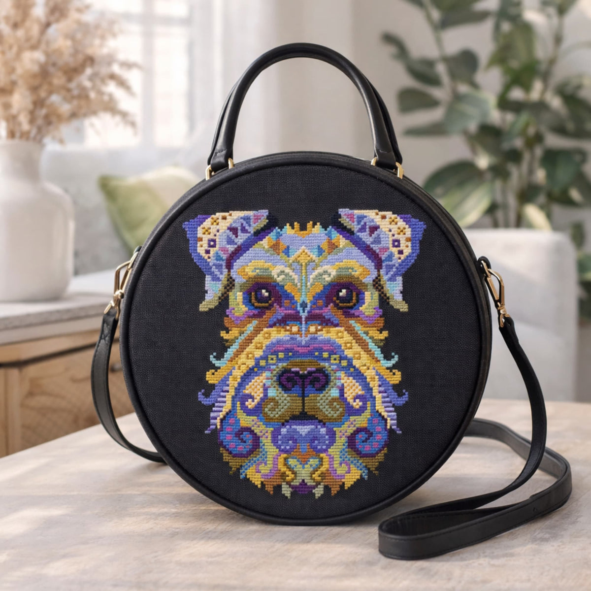 Miniature Schnauzer cross stitch pattern used on black round bag, artistic dog embroidery design for modern decorative textile projects