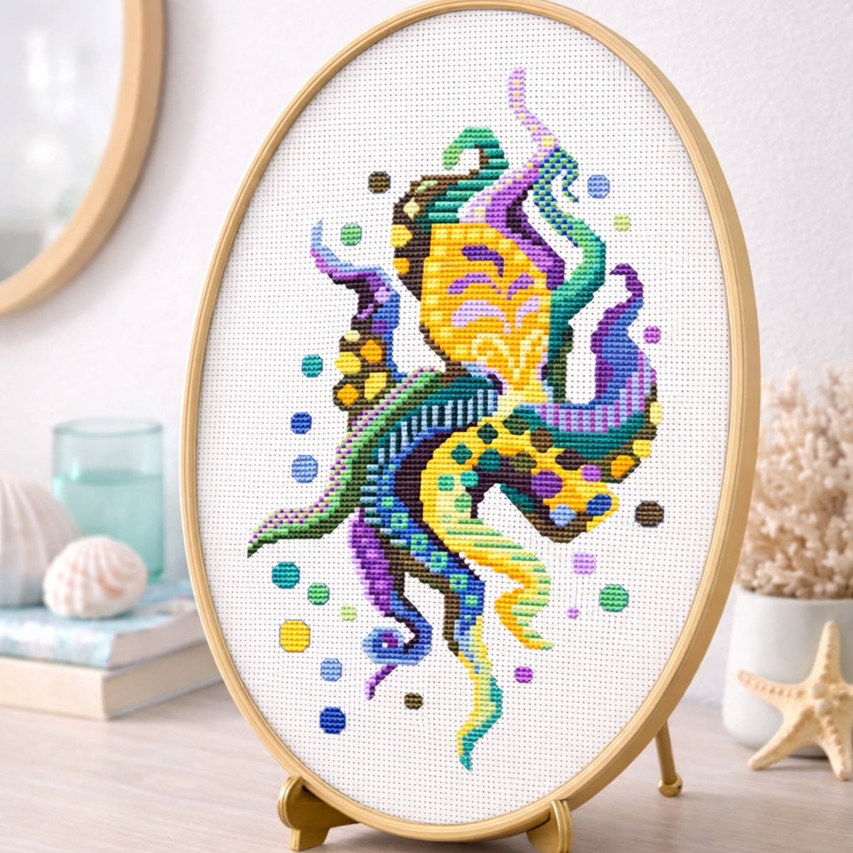 Modern octopus cross stitch pattern PDF shown as framed wall art with vibrant marine animal embroidery design.