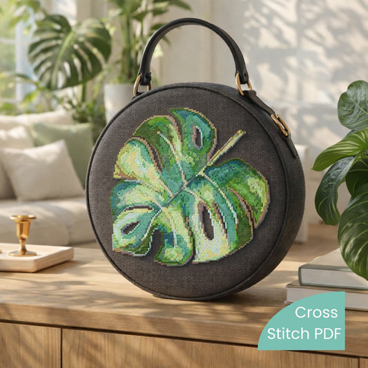 Monstera leaf cross stitch pattern PDF applied on round handbag, tropical plant embroidery design in modern style.