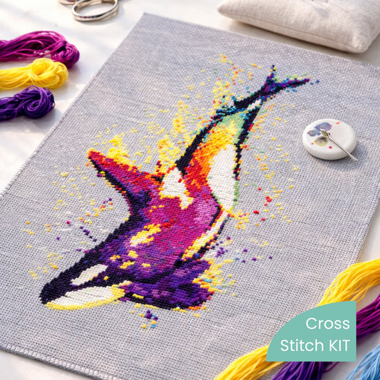 Orca Whale Counted Cross Stitch Kit stitched on fabric with embroidery threads, scissors and pin cushion, modern whale needlework kit.