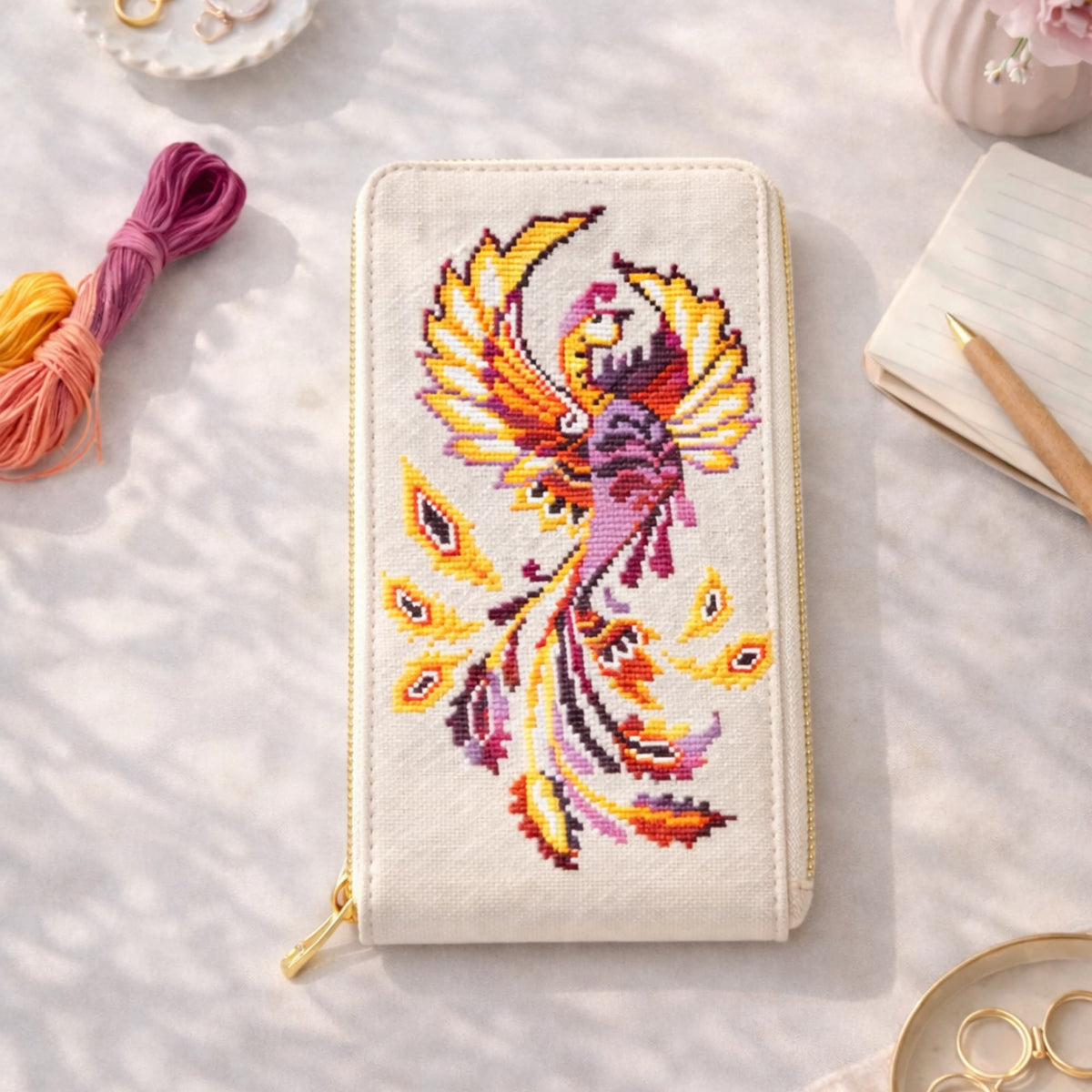 Phoenix Cross Stitch Kit – finished firebird embroidery applied on a handcrafted wallet, vivid phoenix design in warm tones, premium embroidery kit for wearable art