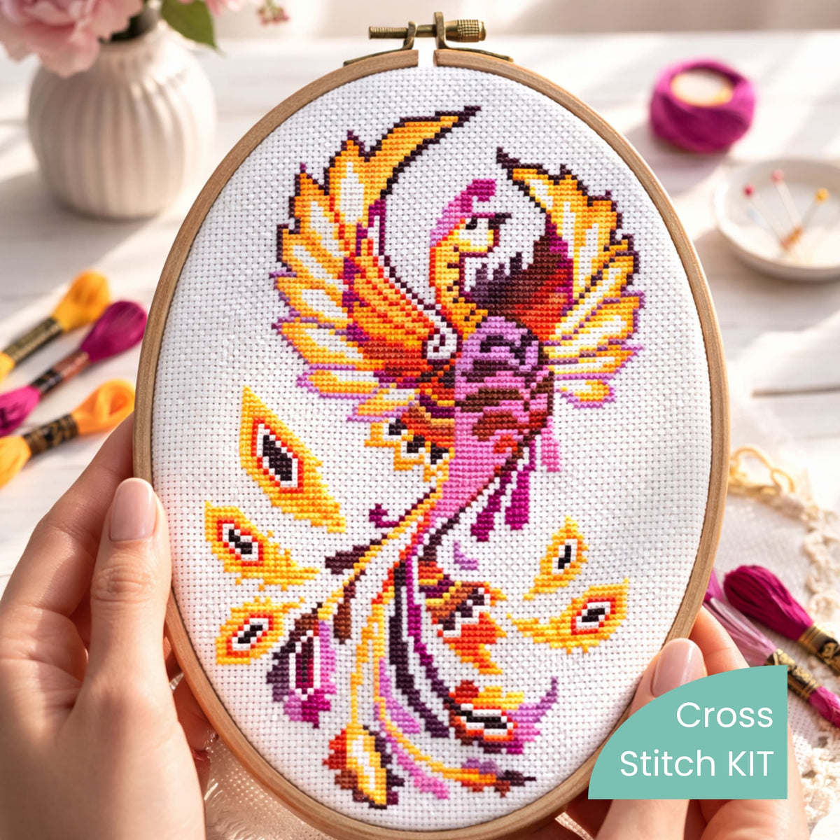 Phoenix Cross Stitch Kit – finished phoenix embroidery in hoop with bright orange and magenta feathers, premium complete embroidery kit for display-ready artwork