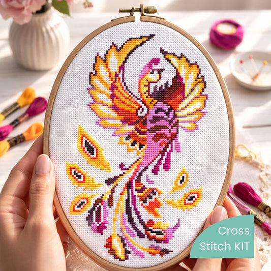 Phoenix Cross Stitch Kit – finished phoenix embroidery in hoop with bright orange and magenta feathers, premium complete embroidery kit for display-ready artwork