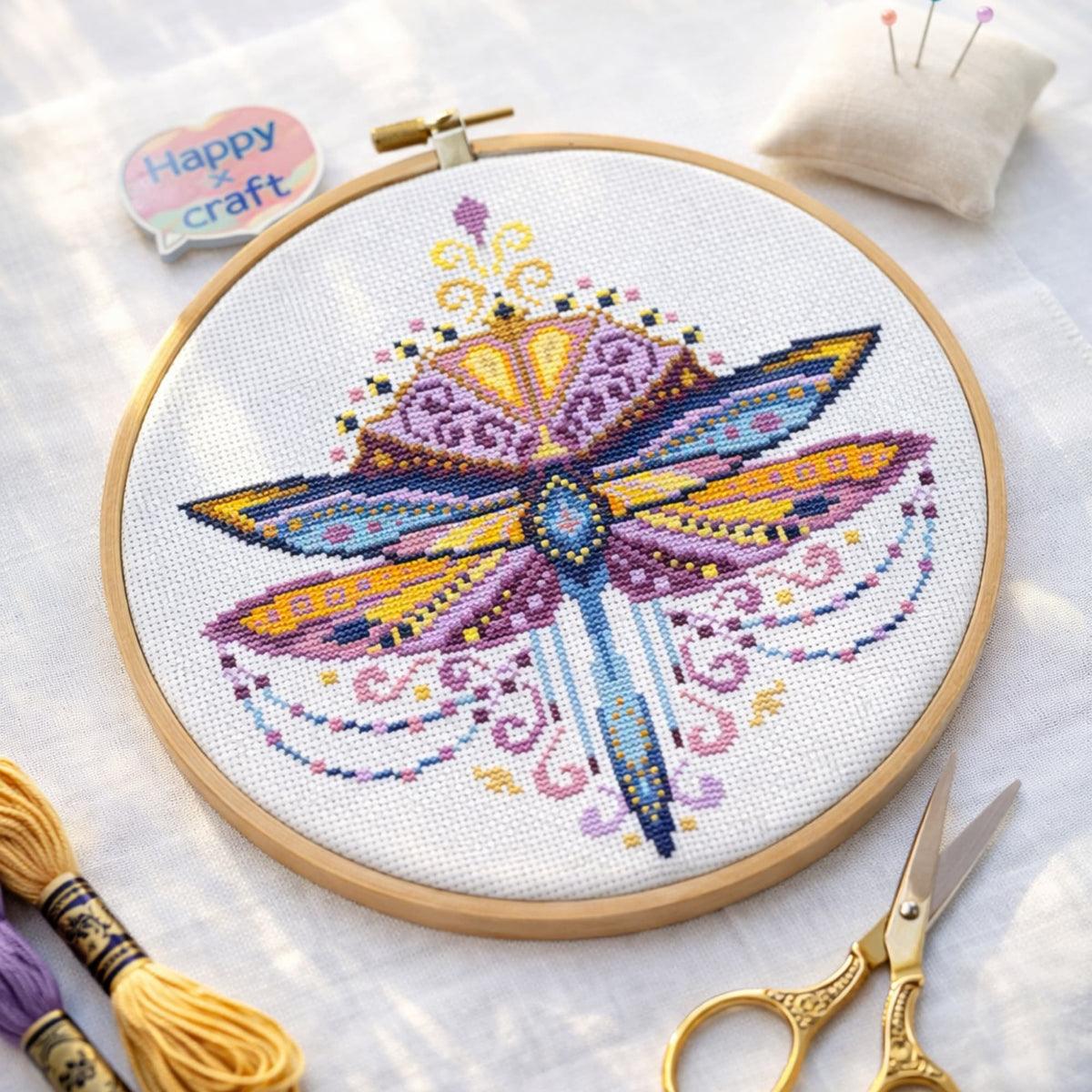 Purple Dragonfly Cross Stitch Pattern PDF digital download displayed in hoop with threads, scissors and embroidery accessories.