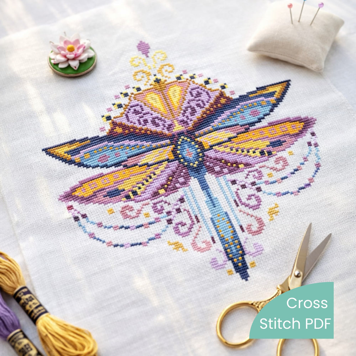 Purple Dragonfly Cross Stitch Pattern PDF digital download featuring finished dragonfly embroidery on fabric with scissors and threads.
