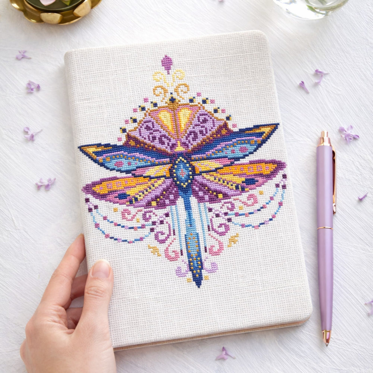 Purple Dragonfly Cross Stitch Pattern PDF digital download showing decorative dragonfly embroidery on fabric notebook cover.