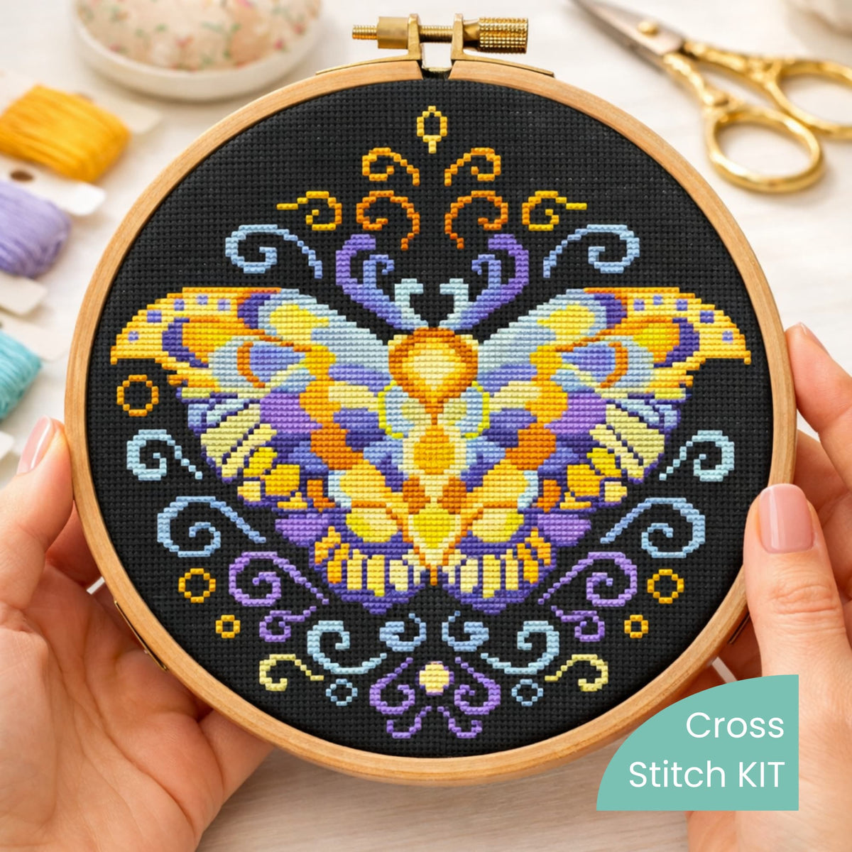 Purple Moth Counted Cross Stitch Kit shown in embroidery hoop with detailed moth needlework design.