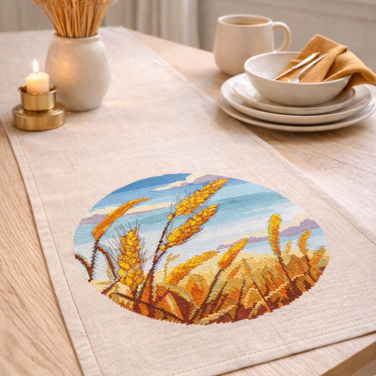 Rustic table runner decorated with wheat field cross stitch pattern, farmhouse harvest embroidery design, handmade countryside textile home decor.