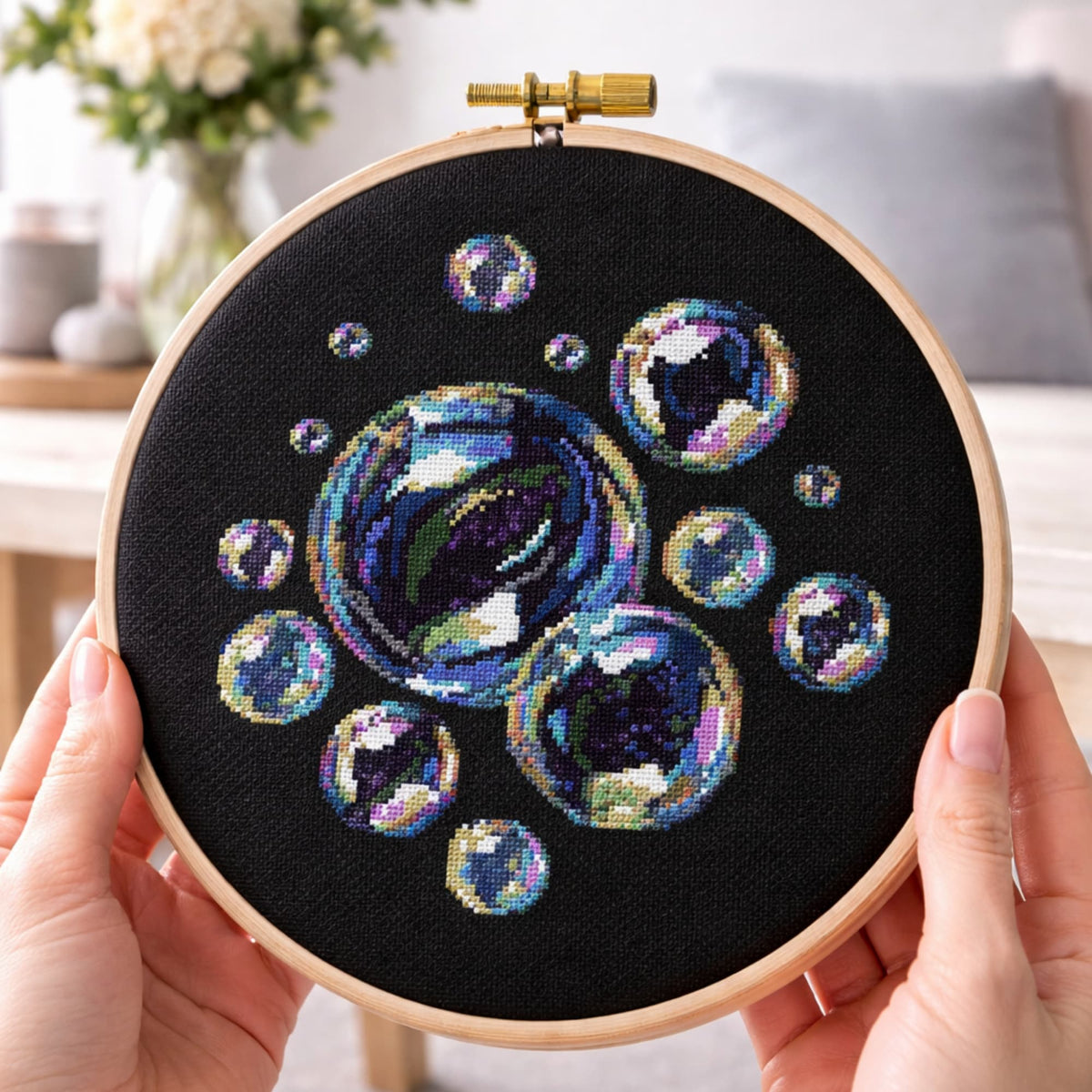 Soap bubbles cross stitch pattern in embroidery hoop held in hands, colorful iridescent bubbles on black fabric, modern cross stitch design PDF