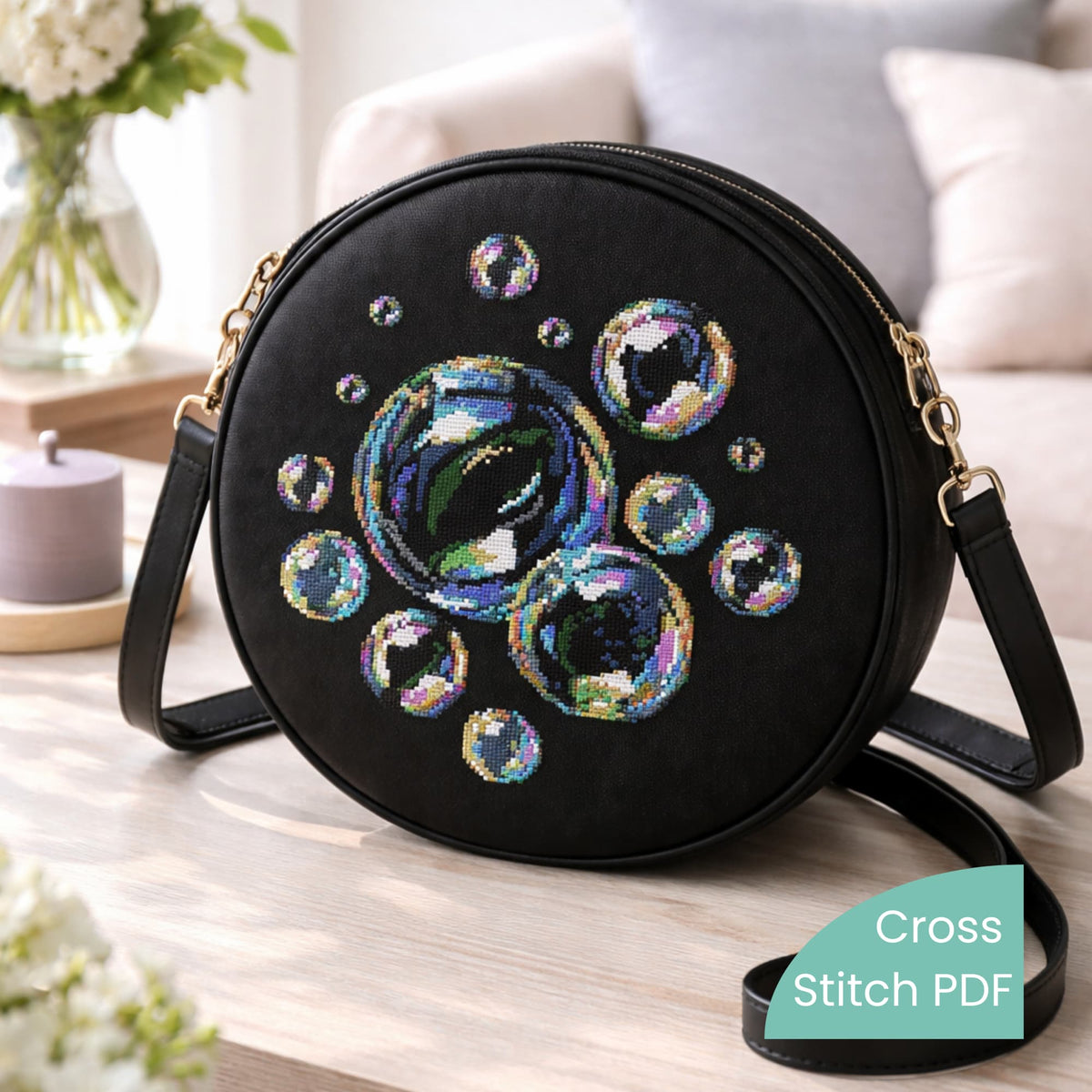 Soap bubbles cross stitch pattern shown on a round black bag, realistic iridescent bubble embroidery design, modern cross stitch PDF pattern