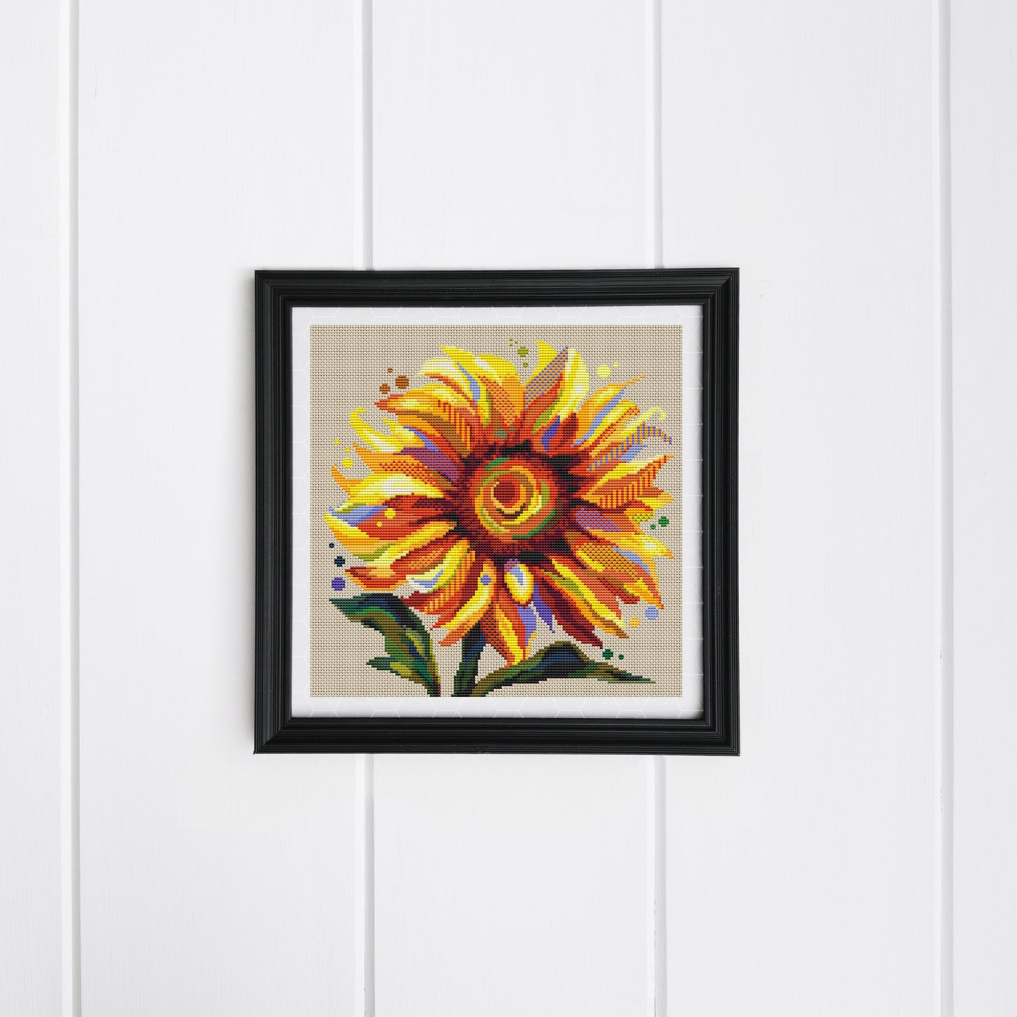 A cross stitch Sun Flower in a frame