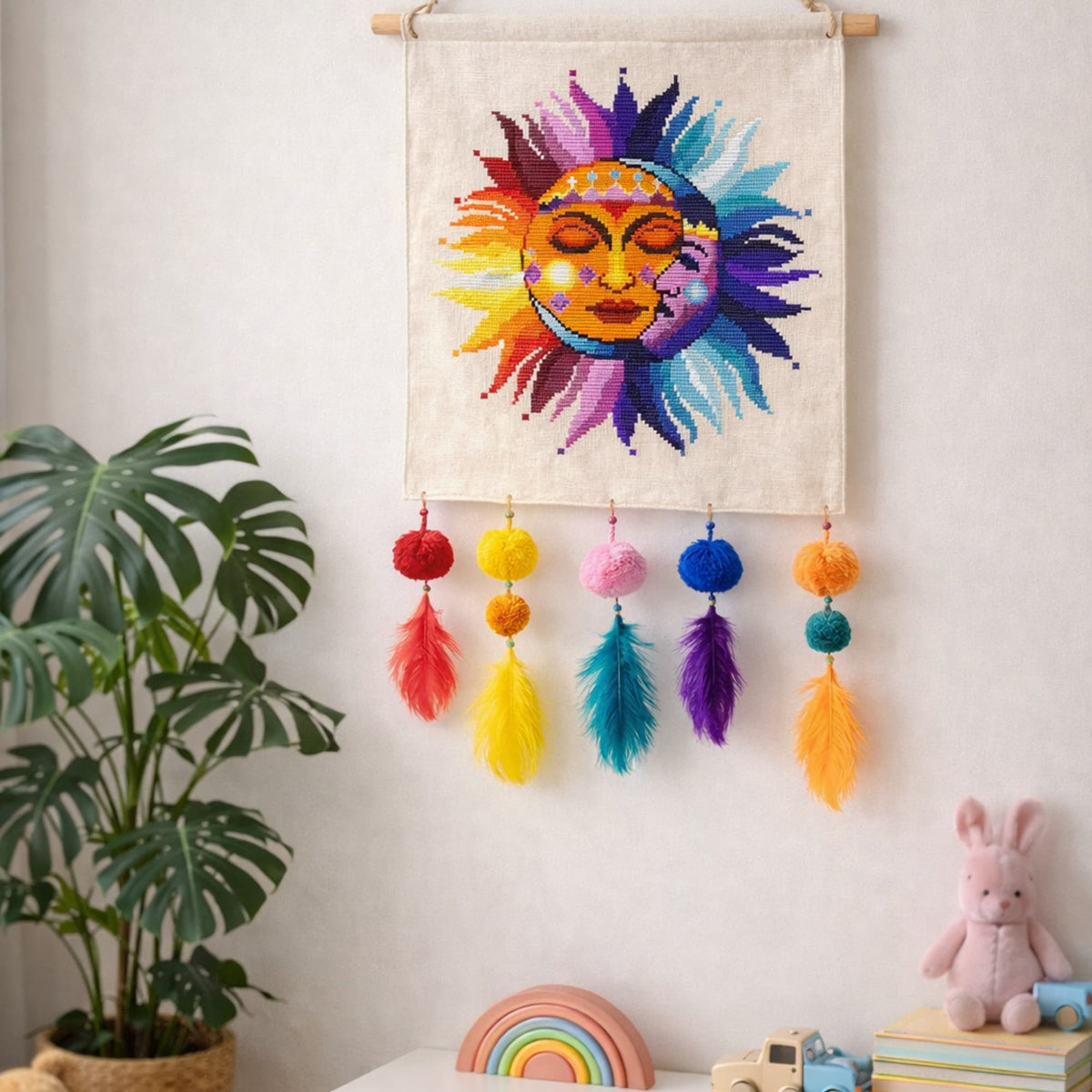 Sun and Moon cross stitch wall hanging on linen fabric with colorful tassels, celestial folk embroidery for boho home decor