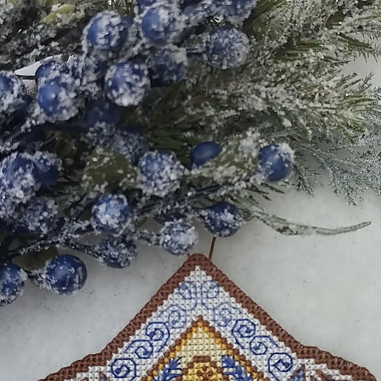 A cross stitch Christmas wallclock in snow