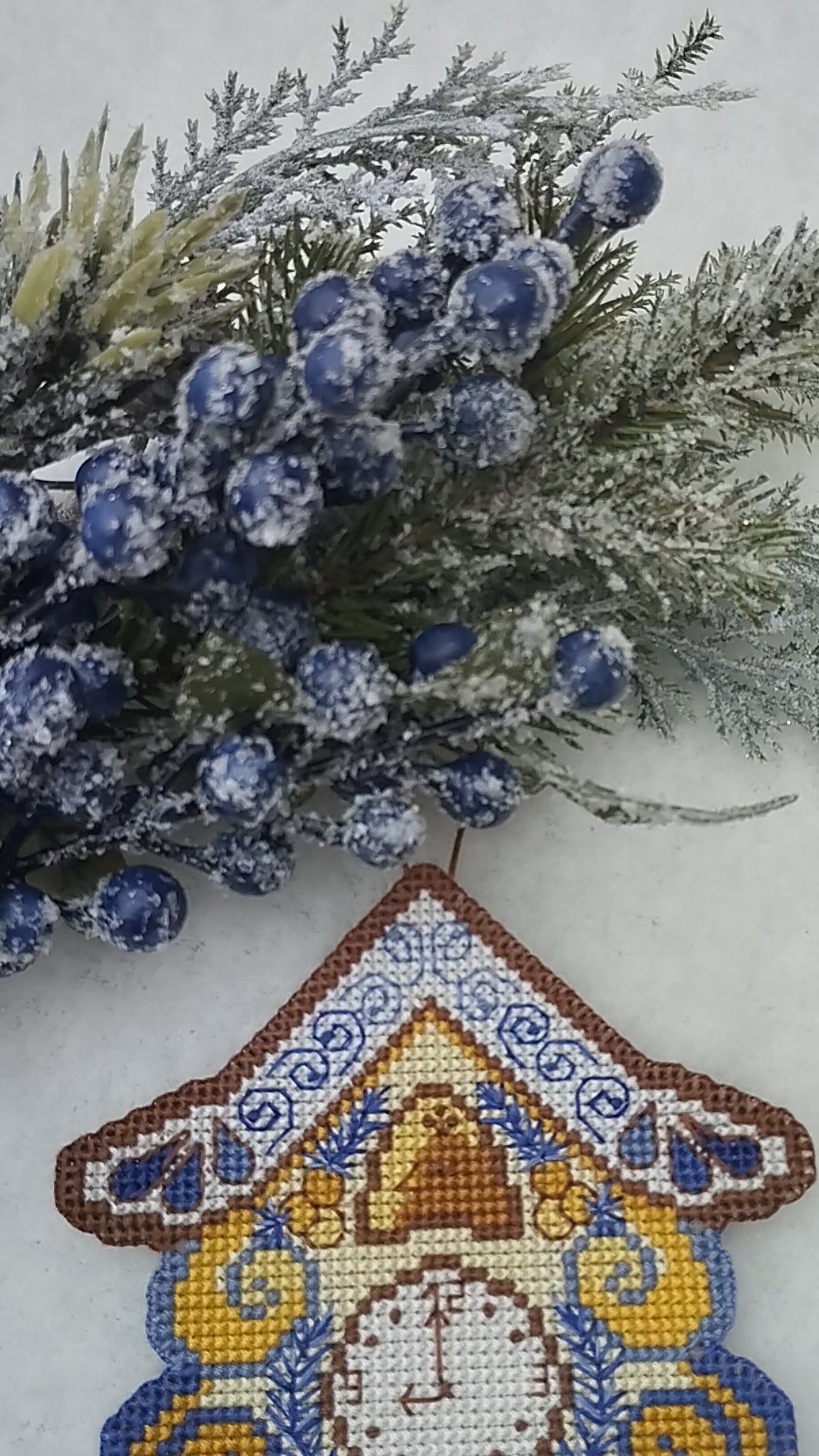 A cross stitch Christmas wallclock in snow