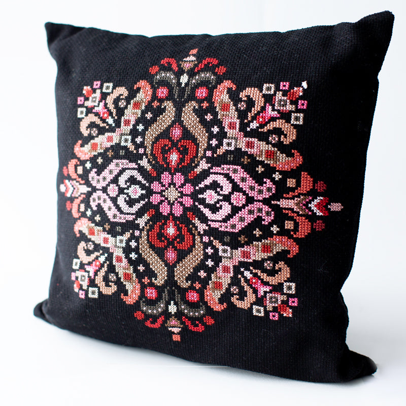 Folk mandala cross stitch kit design displayed on decorative pillow