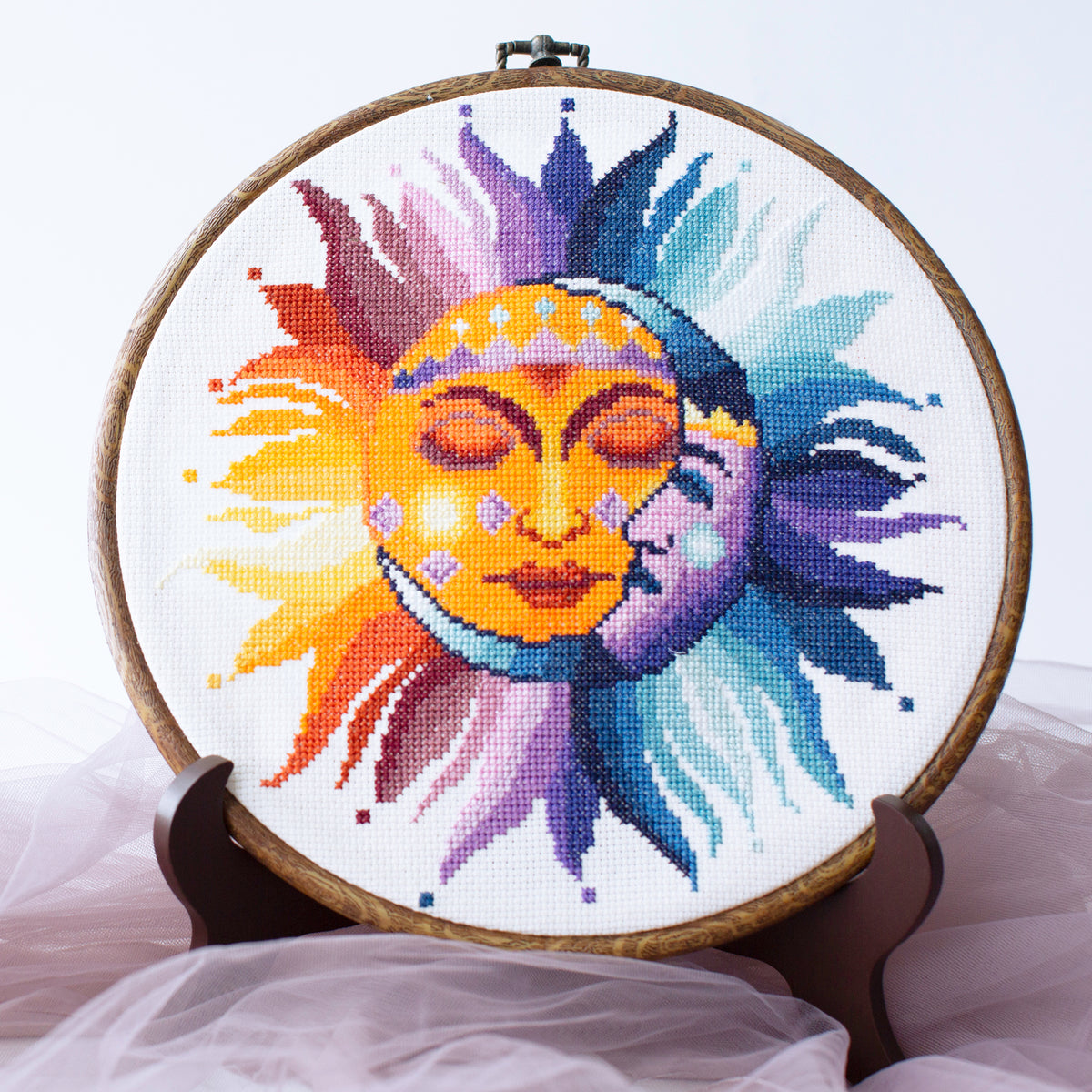 Sun and moon cross stitch kit finished design in embroidery hoop on white Aida fabric, vibrant celestial sun moon DIY kit